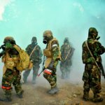 US Navy 110930 N SM578 062 Seabees assigned to Naval Mobile Construction Battalion NMCB 40 conduct drills in full chemical protective gear. v